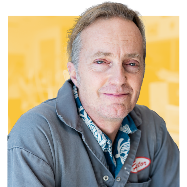 Smiling man in a gray work jacket
